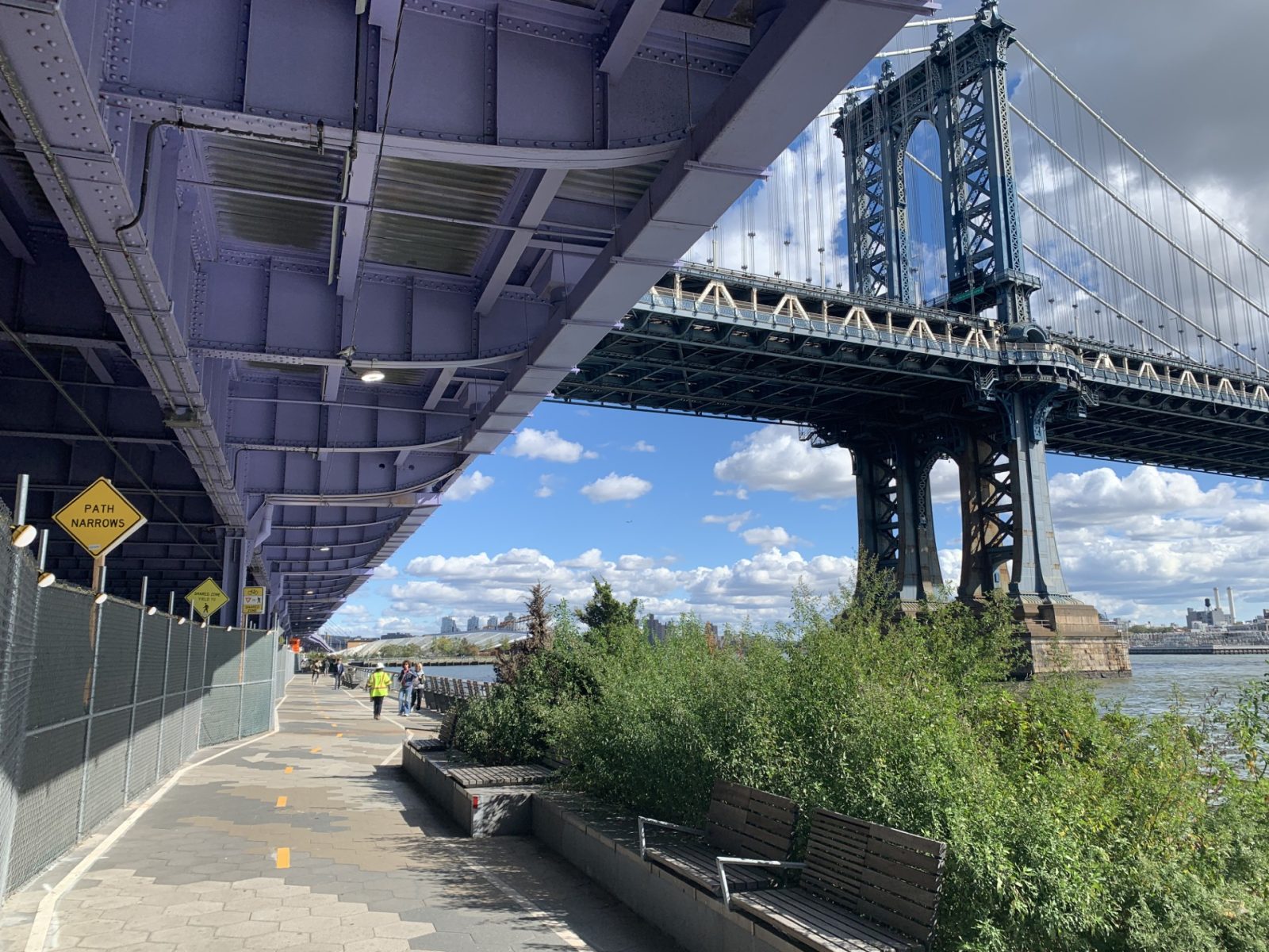bridge and concrete walkway underneath along water