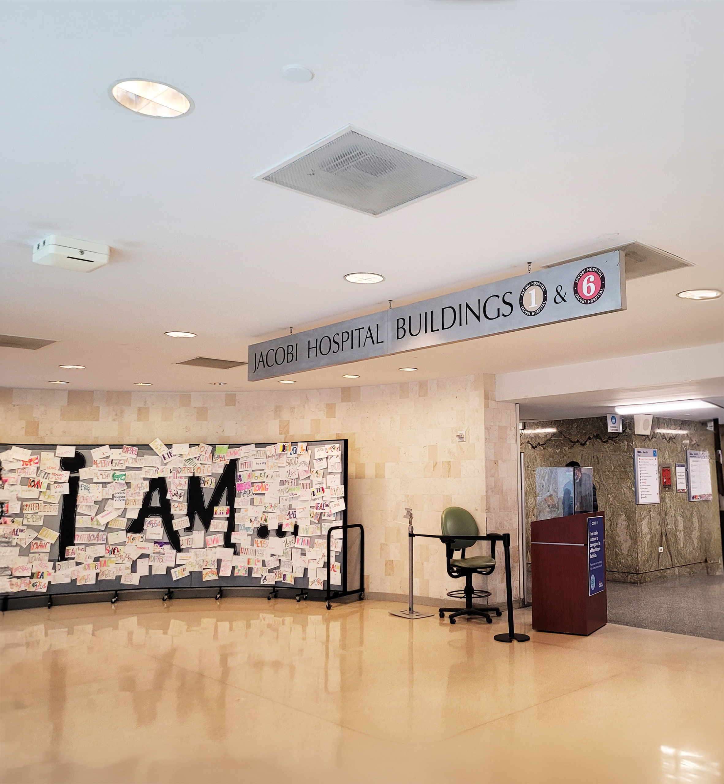 A spacious lobby featuring a prominent sign that reads "I am," inviting visitors to engage with the space.