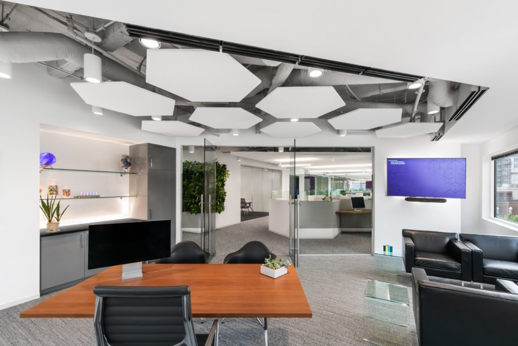 Rendering of office space with desk, counters, and chairs.