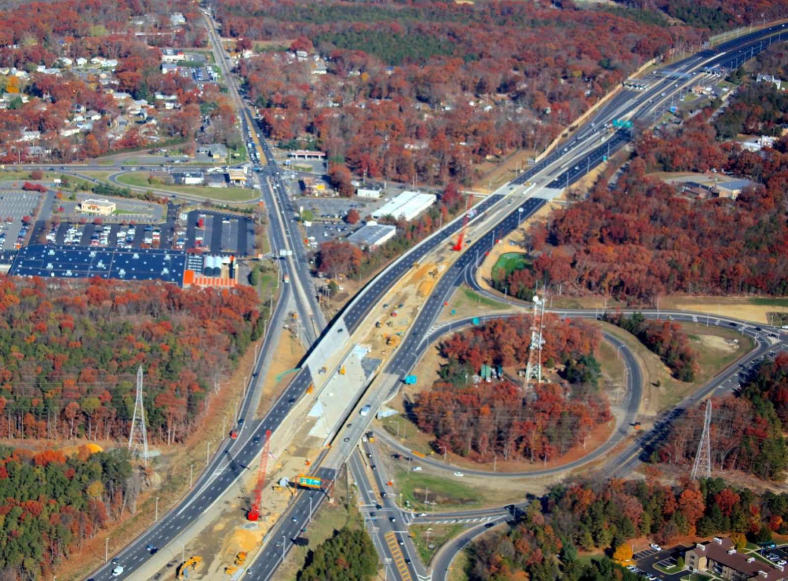 Highway lined with colorful orange, red, and green trees