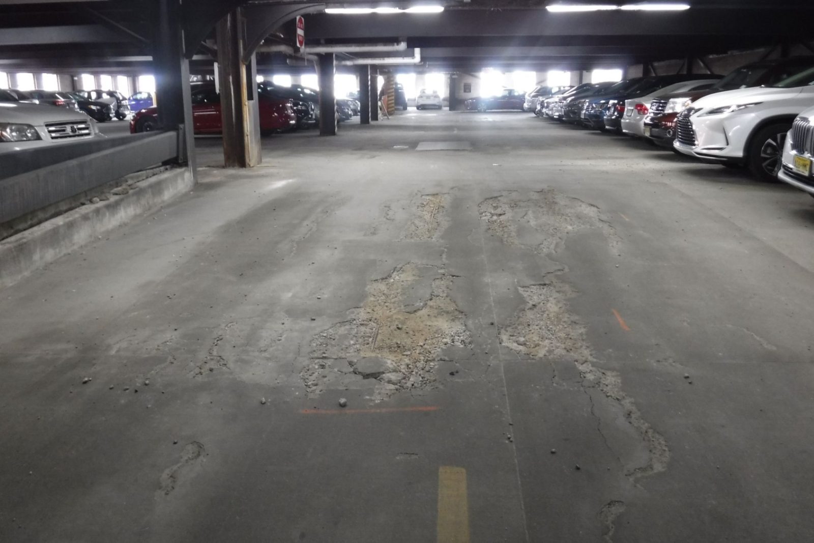 Interior of a parking garage with potholes.