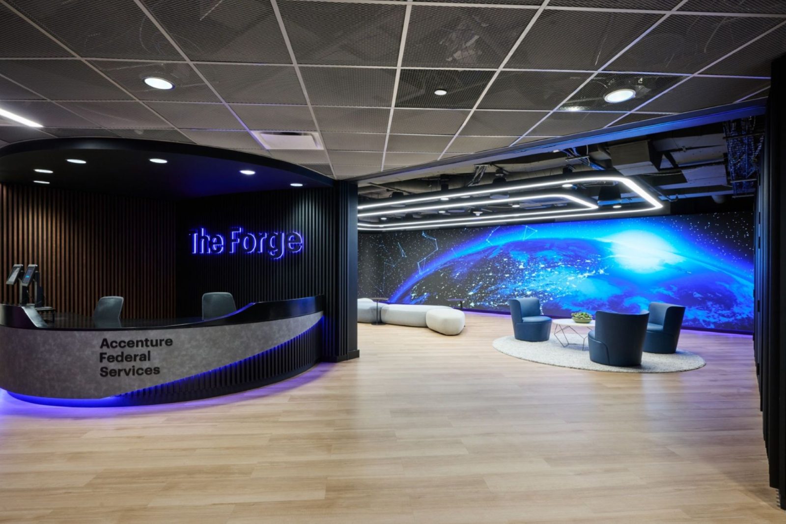 Modern office lobby showcasing a blue wall and a prominent round desk.