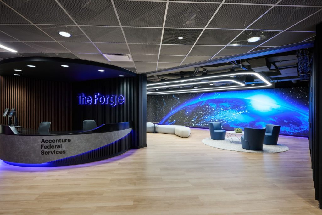 Modern office lobby showcasing a blue wall and a prominent round desk.